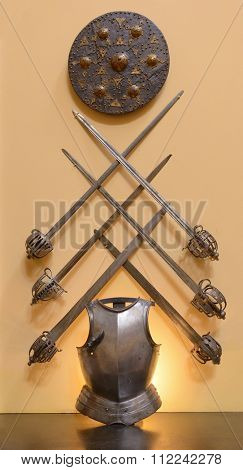 Display of ancient armor consisting of 6 swords, a breastplate and a shield