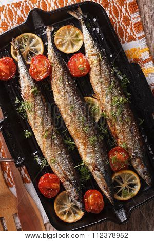 Saury Grilled On A Grill Pan On A Table Close-up. Vertical Top View