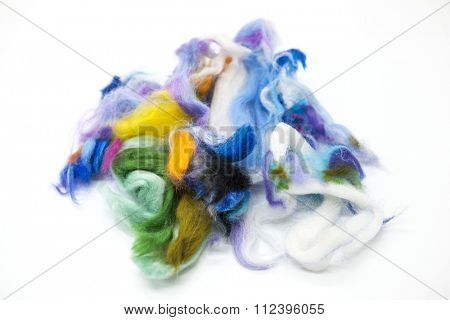Multi-colored piece of Australian sheep wool Merino breed close-up on a white background