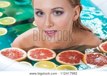 Beautiful woman with shiny skin in blue water