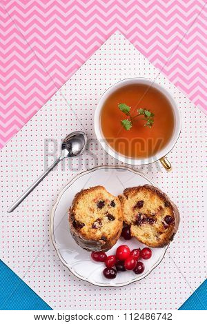 Chocolate Cake With Cranberries On A Saucer And A Cup Of Tea