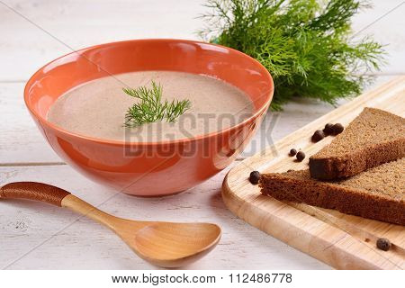 Cream Of Mushroom Soup With Black Bread On A White Wooden Background