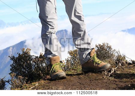 hiking legs enjoy the beautiful landscape on mountian peak