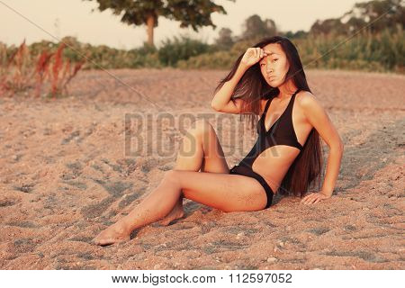 Woman sitting on the sand