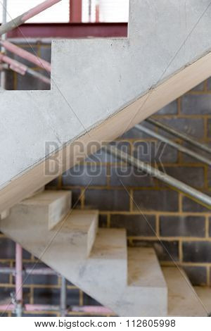 A Construction Site With Concrete Stairs And Scaffolding
