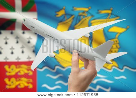 Airplane In Hand With Flag On Background - Saint Pierre And Miquelon