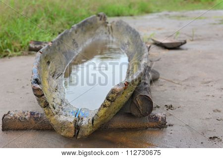 An old Dugout Canoe on the bank of the maranon River in the Peruvian Amazon. Closeup with shallow depth of field in the rain.
