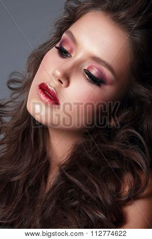 Studio portrait. Portrait of a young woman close-up bright makeup eye shadow.
