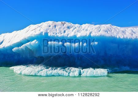 Ice and sun Patagonia, Argentina. Excursion on the tourist boat on Lake Viedma. White and blue huge icebergs floating near the ship broadside