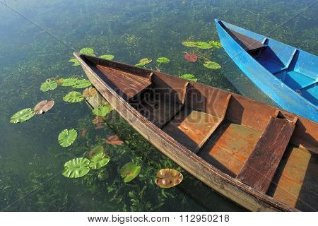 two wooden boats docked on Plav Lake, Montenegro