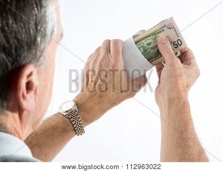 Caucasian Ethnicity Hands Putting Fifty Dollar Bills In Envelope