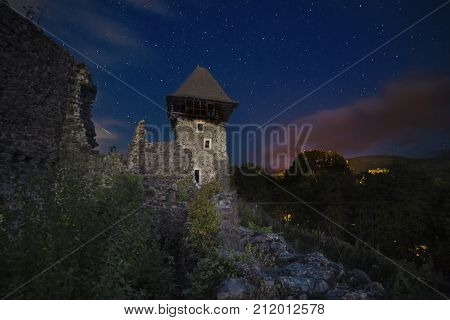 Ruins of Nevitsky Castle near Uzhgorod, Ukraine with a lot of shiny stars on the dark blue sky