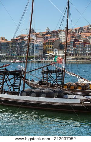 Oporto, Portugal - july 2016: Traditional Rabelo Boat on the Bank of the River Douro and Colorful Facades of Typical Houses- Porto Portugal