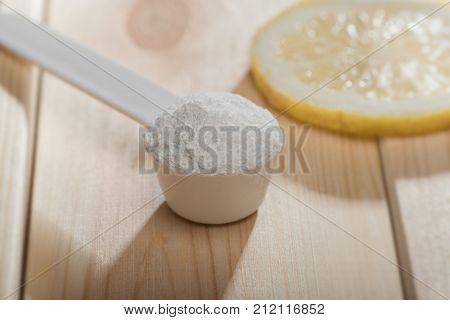 Sport Supplement Or Vitamin With A Lemon Slice. Sport Nutrition Concept.