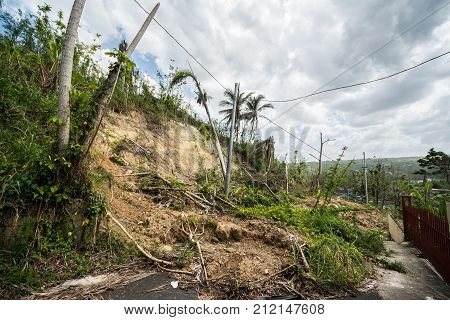 Roadway covered with mudslide from saturated hillside along highway in Puerto Rico