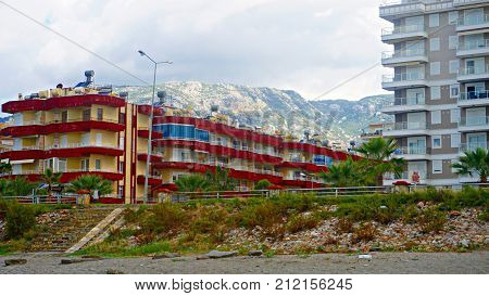 city with mountains in the background . blue clouds