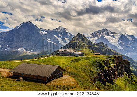 Stunning view on worldfamous mountain trio Eiger Monch and Jungfrau with Tschuggen in the foreground. Seen from Mannlichen in the Bernese Alps in summer. Wengen Bernese Oberland Switzerland