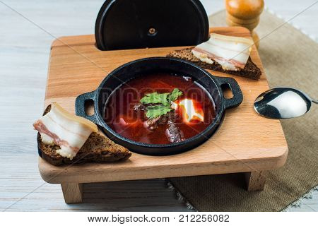 Borscht-beet soup in a cast iron bowl , a traditional dish of Ukrainian cuisine.