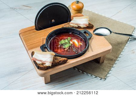 Borscht-beet soup in a cast iron bowl , a traditional dish of Ukrainian cuisine.