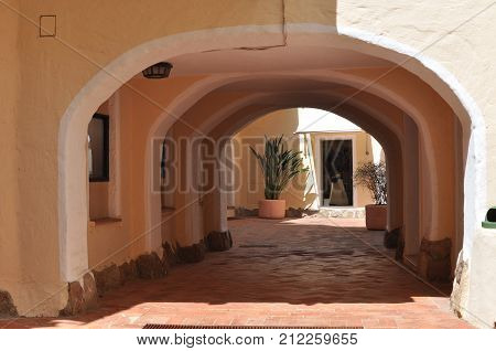 PORTO CERVO ITALY- July 2017 - Coastline promenade with pine trees and tourquise clear water at Porto Cervo town. Porto Cervo is capital of Costa Smeralda Sardinia Italy.