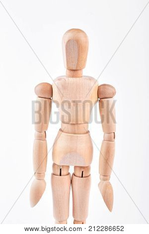 Human wooden dummy standing over white. Wooden figurine isolated on white background.