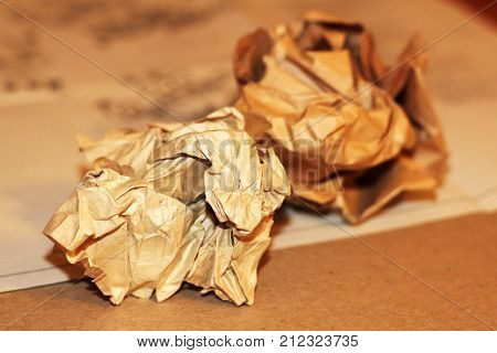 Close-up Of Crumpled Paper Balls On A White Wooden Background With Pencils And Pencil Shavings.