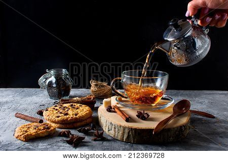 Cup Of  Tea, Biscuits, Cinnamon, Anise On Dark   Background