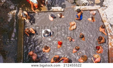 Soufriere, Saint Lucia - May 12, 2016: The tourists swimming at the Sulphur Springs Drive in volcano near Soufriere on 12 may 2016 at Saint Lucia island