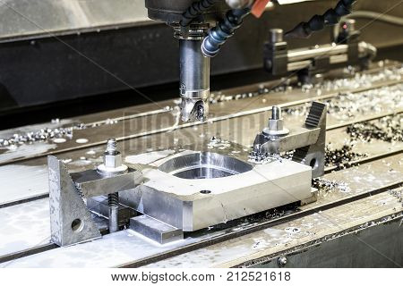 Cutting metalworking process. Square industrial metal mold/blank milling at factory. Mechanical engineering lathe drilling industry CNC technology. Indoors horizontal image.