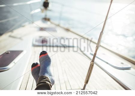 Closeup on women's feet in socks on the yacht, lifestyle, pleasure concept. carefree vacation