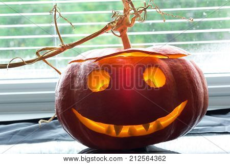carved pumpkin face with a lighting for hellowing