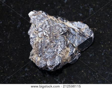 Rough Ilmenite Stone On Dark Granite Background