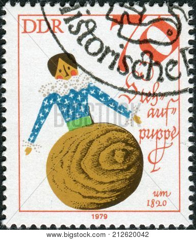 GERMANY - CIRCA 1979: Postage stamp printed in Germany (GDR) shows a vintage doll - Tumbler 1820 circa 1979