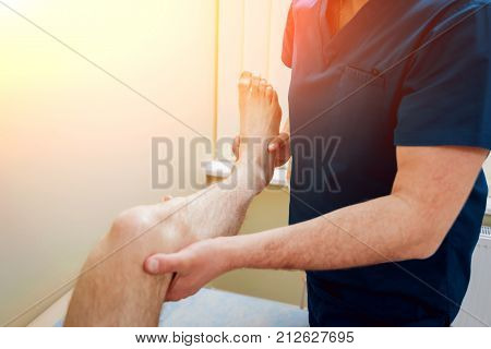 Patient with orthopedist doctor in his office. Knee injury