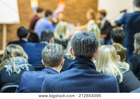 Audience Looking at the Group of Young Professional Mediators Having a Public Discussion at the Round Table on Stage Before the Audience.Vertical Image Orientation