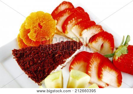 cream cake, raw apple, and strawberry on plate