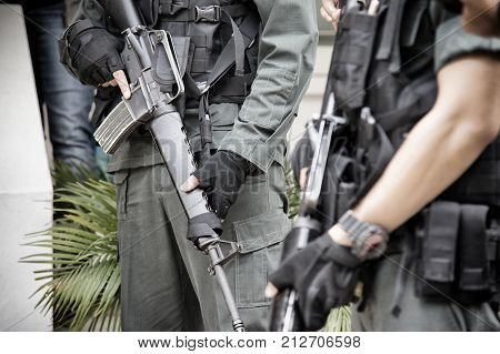Thai soldier holding  gun in full army uniform.Thai military in Thailand curfew zone