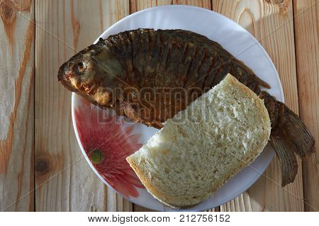 Delicious food - fried fish in flour on sunflower oil has a golden crust and a pleasant smell.