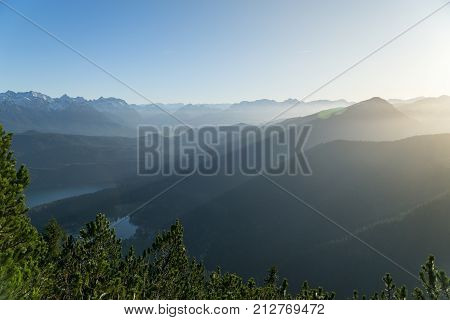 Panoramic view from Herzogstand with the mountainscape with foggy sunset