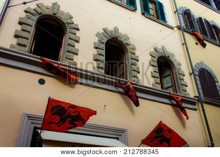 Medieval banners resting on windows for historical reenactment.