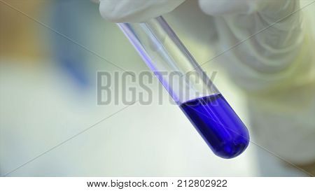 Test tubes closeup. Medical equipment. Close-up footage of a scientist using a micro pipette in a laboratory. Laboratory technician injecting liquid into a microtiter plate. Test tubes. Doctor at hospital checked sample in machine above view.