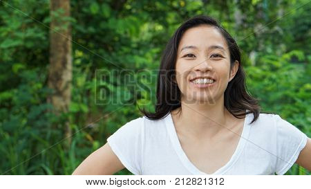 Asian Woman Long Hair With Facial Epression Green Nature Background