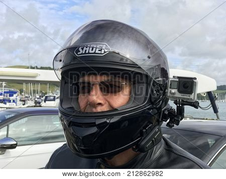 Dartmouth, Devon, United Kingdom. 27th July 2017. Motorbike rider wearing a Go Pro Hero 4 black action video camera with Bluetooth communication device.   Useful for recording traffic incidents. 