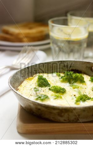 Omelette With Broccoli And Cheese Served With Bread Toasts And Lemonade.