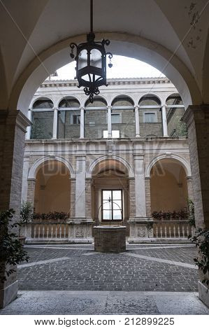 FERMO, ITALY - JULY 9, 2017: Fermo (Marches Italy): historic buildings along an old typical street at evening. Courtyard