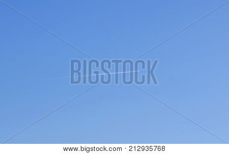 Trace from the plane in the blue sky.
