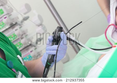 Male doctor performs a scheduled endoscopic check-up to the patient.