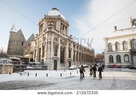 GHENT BELGIUM - CIRCA 2010: School children cycling in winter through the streets of Ghent Belgium