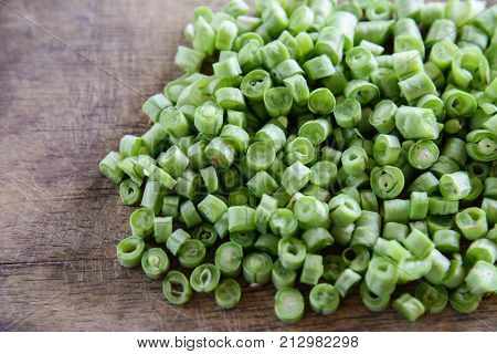 Sliced yard long bean vegetable on wooden block.long bean preparation in thai kitchen.