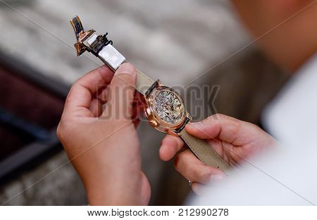 wrist watch with leather wristband strap on hand